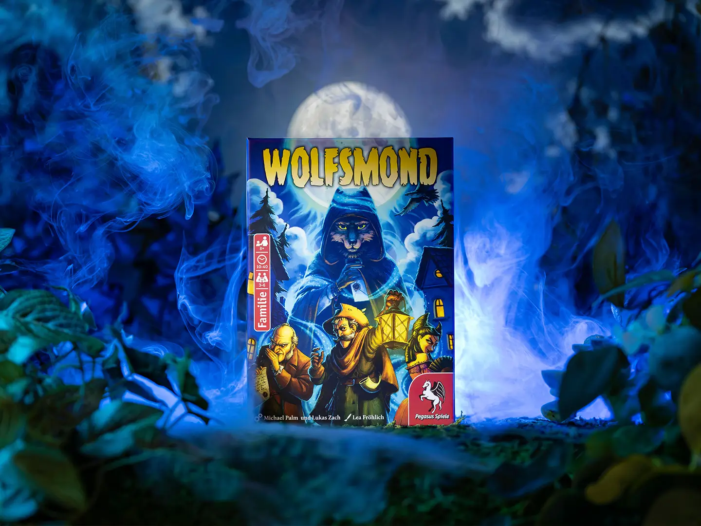 Spielschachtel von Wolfsmond mit einer vermummten Wolfsgestalt und drei weiteren Figuren vor einem Vollmond, umgeben von blauem Nebel.